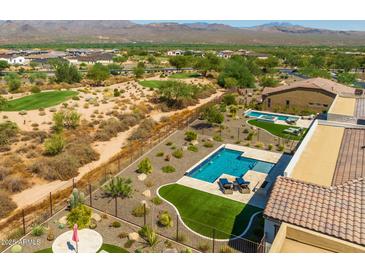 A high-angle shot shows the backyard swimming pool, golf course, and the desert landscape surrounding the house at 18016 E Wolf Tree Ln, Rio Verde, AZ 85263