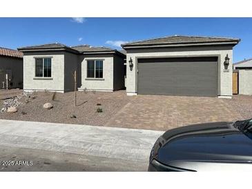 Charming single-story home with a two-car garage, low-maintenance landscaping, and neutral color palette at 18110 W Silverwood Dr, Goodyear, AZ 85338