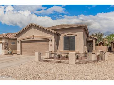 Charming single-story home featuring a stucco exterior, well-maintained landscaping, and attached two-car garage at 20916 E Desert Hills Blvd, Queen Creek, AZ 85142