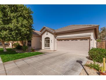 Charming single story home with a well-manicured lawn, desert landscaping and a two car garage at 2450 E Glass Ln, Phoenix, AZ 85042