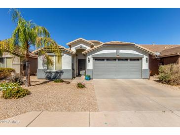 Charming single-story home featuring a well-maintained front yard and a two-car garage at 3284 W Five Mile Peak Dr, San Tan Valley, AZ 85144