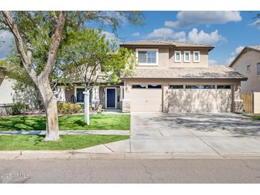 Beautiful two-story home with a three car garage and well-manicured lawn at 3336 E Linda Ct, Gilbert, AZ 85234