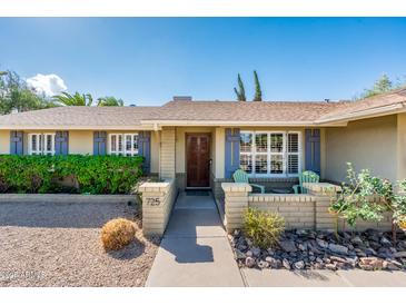 Charming single-story home featuring a manicured front yard and a welcoming front entrance at 725 E Country Gables Dr, Phoenix, AZ 85022