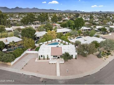 Expansive aerial view of a property featuring a pool, complemented by lush landscaping and scenic mountain views at 8405 N Via Mia --, Scottsdale, AZ 85258