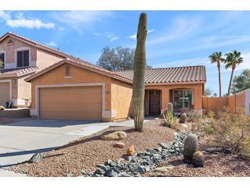 Charming single-story home with desert landscaping and a two car garage, with bright blue sky at 15853 S 17Th Dr, Phoenix, AZ 85045