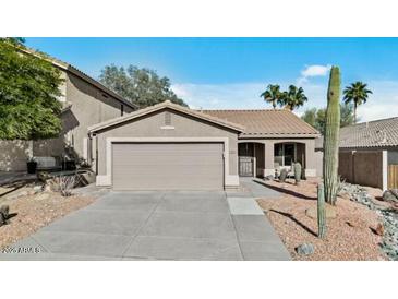 Charming single-story home featuring a two-car garage and desert landscaping at 15853 S 17Th Dr, Phoenix, AZ 85045