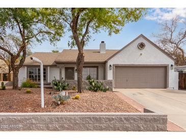 Charming single-story home featuring desert landscaping, a two-car garage, and inviting curb appeal at 19601 N 14Th St, Phoenix, AZ 85024