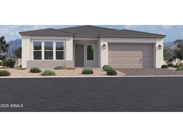 Charming single-story home with a two-car garage and well-maintained landscaping at 22685 E Saddle Way, Queen Creek, AZ 85142