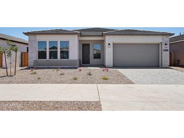 Charming single-story home with a neutral color palette, low-maintenance landscaping, and a two-car garage at 22685 E Saddle Way, Queen Creek, AZ 85142