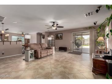 Bright, open living area with neutral colors, tile floors, and sliding glass doors to the outdoor space at 33224 N Cat Hills Ave, San Tan Valley, AZ 85144