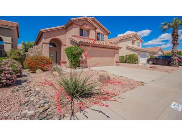 Charming two-story home featuring desert landscaping and a private two-car garage at 4714 E Angela Dr, Phoenix, AZ 85032