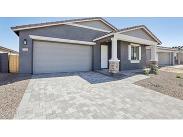 Charming home featuring a two-car garage and a well-manicured front yard and walkway at 7701 W Avenida Del Rey --, Peoria, AZ 85383