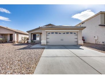 Charming single-story home featuring a two-car garage and low-maintenance desert landscaping at 849 E Impreria St, San Tan Valley, AZ 85140