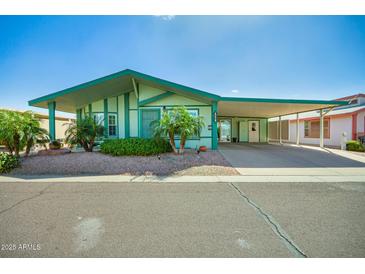 Charming single-story home featuring desert landscaping, a covered porch, and a spacious carport at 8500 E Southern Ave # 447, Mesa, AZ 85209