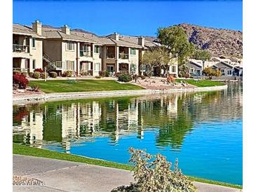 Scenic waterfront view of townhomes with balconies reflecting in the lake on a clear day at 16013 S Desert Foothills Pkwy # 2120, Phoenix, AZ 85048