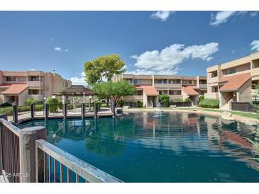 Scenic condo community with pond, mature trees, and waterfront gazebo at 1645 W Baseline Rd # 2122, Mesa, AZ 85202