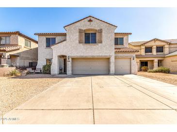 Charming two-story home with a three car garage, desert landscaping, and a neutral color palette at 19061 N Toya St, Maricopa, AZ 85138
