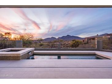 Stunning pool and spa combo overlooks beautiful desert landscape and breathtaking mountain views at 40198 N 105Th Pl, Scottsdale, AZ 85262