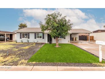 Charming single-story home featuring a low maintenance front yard and a convenient carport at 5016 N 68Th Dr, Glendale, AZ 85303