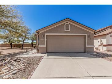 Beautiful home featuring a two-car garage, complemented by desert-friendly landscaping at 9644 N 97Th Ln, Peoria, AZ 85345