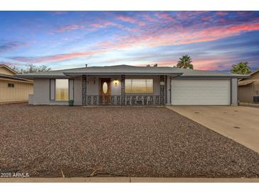 Charming single-story home with gray brick, low maintenance yard and two car garage at 14013 N Boswell Blvd, Sun City, AZ 85351