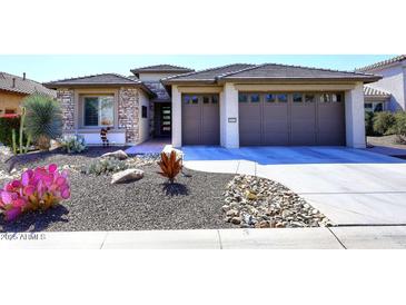 Charming single-story home with desert landscaping and a two-car garage in a sunny neighborhood at 16935 W Cambridge Ave # 57, Goodyear, AZ 85395