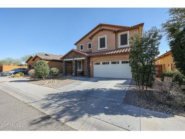 Charming two-story home featuring a two car garage and meticulously landscaped front yard at 1713 W Cottonwood Ln, Phoenix, AZ 85045