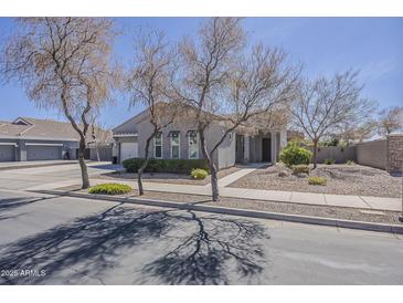 Charming single-story home featuring desert landscaping, neutral tones, and a welcoming entrance at 21359 E Camacho Rd, Queen Creek, AZ 85142