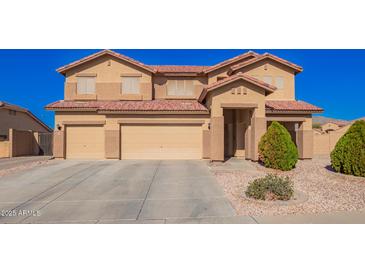 Spacious home with a three-car garage and well-maintained front yard and appealing desert landscaping at 224 N 236Th Ave, Buckeye, AZ 85396