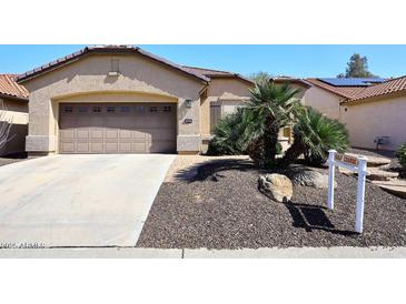 Charming single-level home with a two-car garage and desert landscaping, nearby a golf course at 3685 N 162Nd Ln, Goodyear, AZ 85395