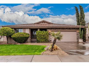 Charming single-story home featuring beautiful landscaping, a two-car garage and stone accents at 3881 S Marion Way, Chandler, AZ 85286