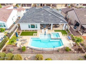 Aerial view of the backyard pool and jacuzzi, covered patio and fenced yard at 4319 W Winslow Way, Eloy, AZ 85131