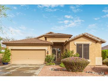 Charming single-Gathering home boasts a well-maintained front yard with a two-car garage, beautiful plants and rock landscaping at 4806 E Thunderbird Dr, Chandler, AZ 85249