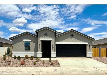 Charming single-story home with a well-manicured yard and a two-car garage at 8486 W Mantle Way, Florence, AZ 85132