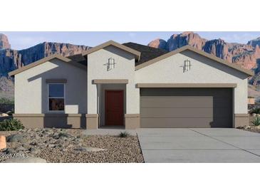 Attractive single-story home with a two-car garage and desert landscaping at 8486 W Mantle Way, Florence, AZ 85132