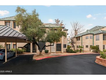 Condominium complex featuring desert landscaping, covered parking, and neutral color palette at 101 N 7Th St # 137, Phoenix, AZ 85034