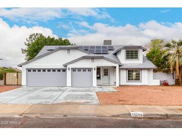 Charming home featuring a well-maintained yard, three-car garage, and solar panels at 13244 N 54Th Dr, Glendale, AZ 85304