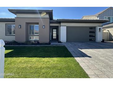 Charming single-story home with a well-manicured lawn, modern architecture, and inviting curb appeal at 1511 E Lynx Way, Gilbert, AZ 85298