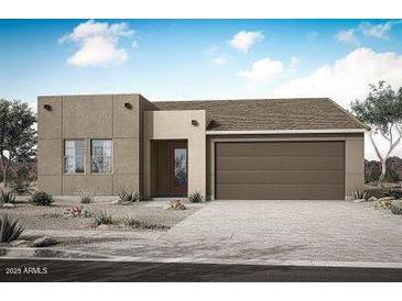 Contemporary single-story home with a two-car garage and desert landscaping on a sunny day at 17253 W Via Dona Rd, Surprise, AZ 85387