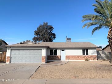 Charming single-story home featuring a two-car garage, desert landscaping, and a freshly painted exterior at 2632 E Irwin Ave, Mesa, AZ 85204