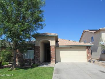 Charming single-story home featuring a well-manicured lawn and a two-car garage at 2830 W Grenadine Rd, Phoenix, AZ 85041