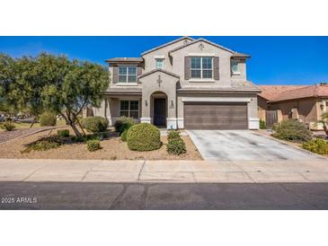 Traditional two-story home with a well-manicured front yard and a two car garage at 42256 W Lucera Ln, Maricopa, AZ 85138