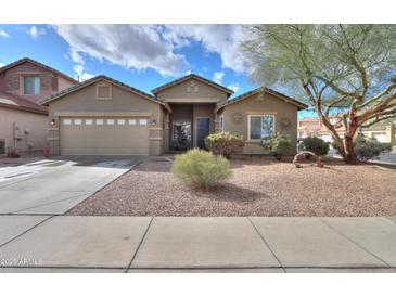 Charming single-story home with desert landscaping, a two-car garage and sunny skies at 46175 W Morning View Ln, Maricopa, AZ 85139