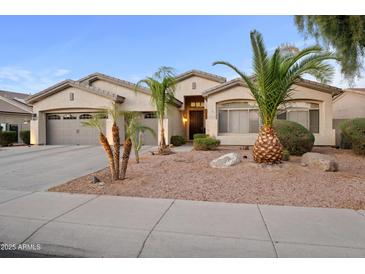 Charming single-story home with a three-car garage and desert landscaping at 686 E Vermont Dr, Gilbert, AZ 85295