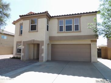 Two-story home featuring a two-car garage, neutral stucco, and a tile roof at 8163 E Posada Ave, Mesa, AZ 85212