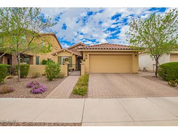 Charming single level home with a well-manicured front yard and brick paved driveway at 10156 E Radiant Ave, Mesa, AZ 85212