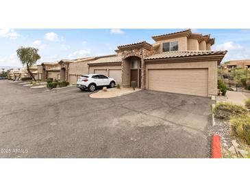 Charming townhome with two-car garage, stone accents, and desert landscaping providing a welcoming entrance at 13700 N Fountain Hills Blvd # 365, Fountain Hills, AZ 85268