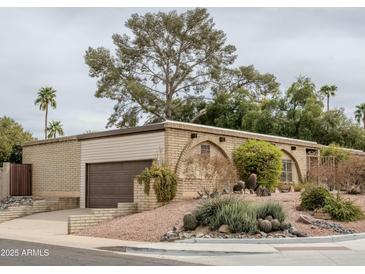 Charming single-story home with a well-maintained desert landscape and attached garage at 14625 N 25Th Pl, Phoenix, AZ 85032