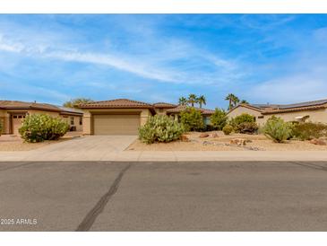 Charming single-story home featuring desert landscaping, a two-car garage, and a tile roof at 15046 W Cooperstown Way, Surprise, AZ 85374