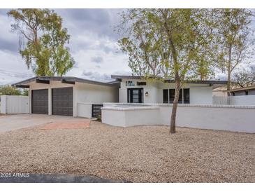 Charming single-story home with a two-car garage and low-maintenance desert landscaping in front at 15255 N 5Th Ln, Phoenix, AZ 85023